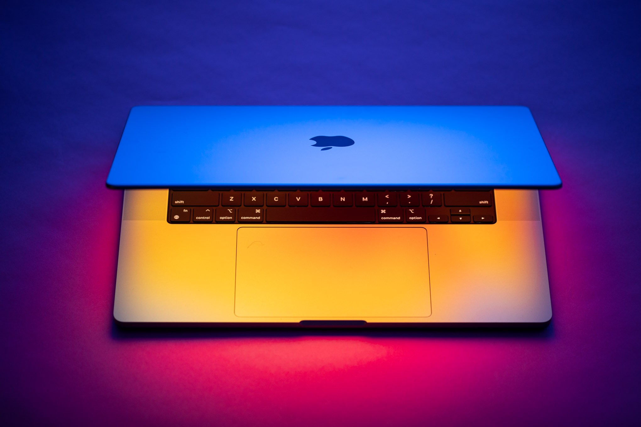 A person using a touchscreen laptop, with a finger touching the display.