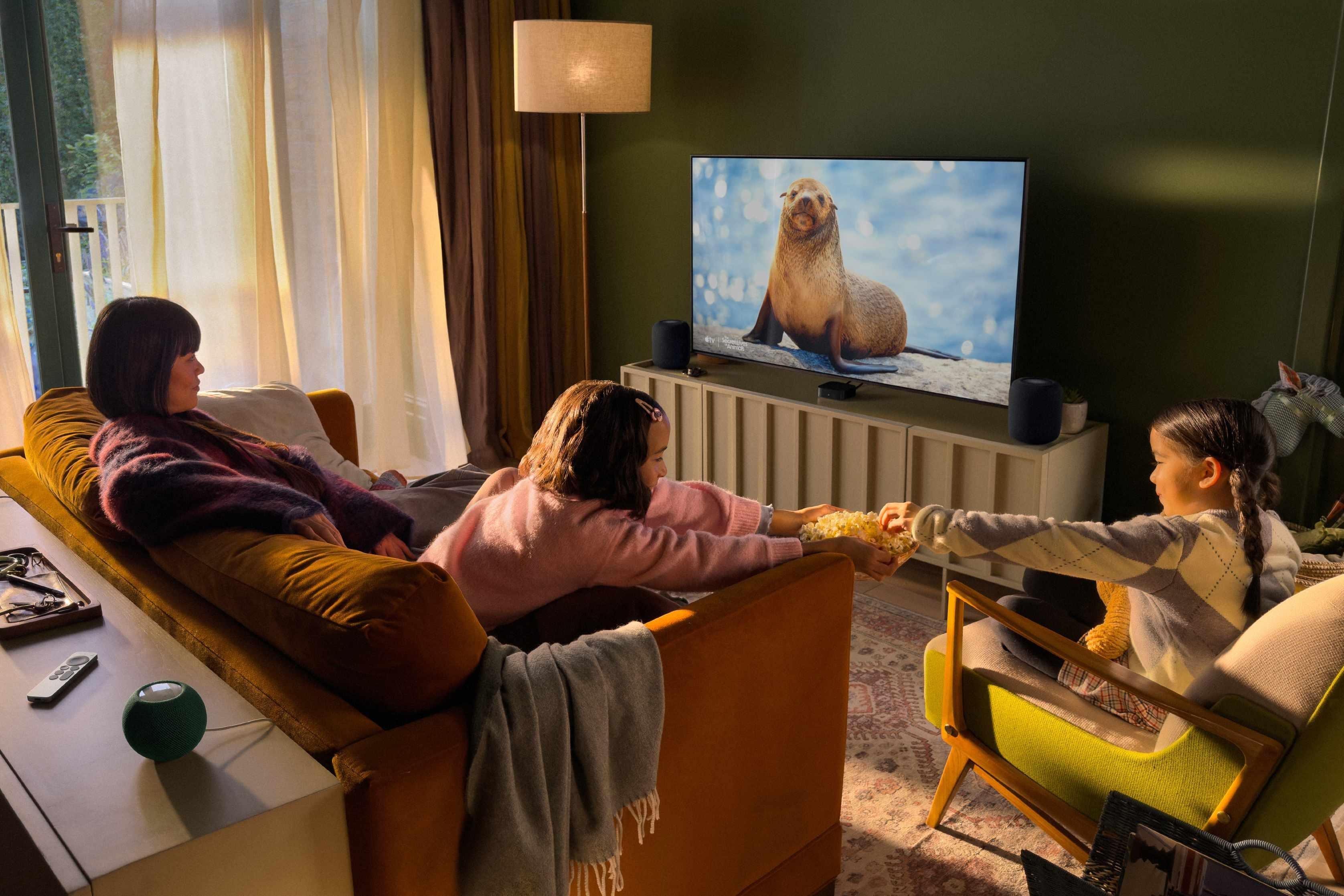 Apple TV 4K streaming box with Siri Remote displayed against a colorful gradient background