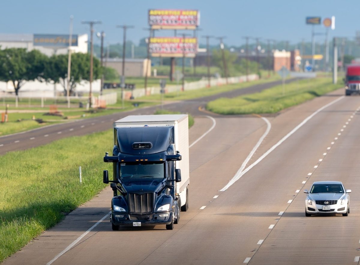 Aurora self-driving truck on a highway representing the company's autonomous freight expansion plans